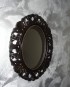 Miroir ovale noir patiné or